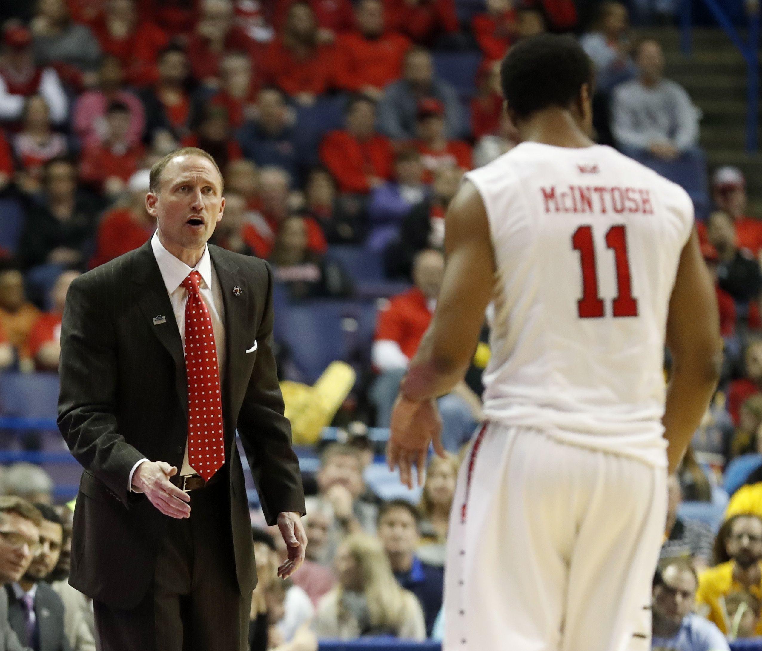 Illinois State head coach Dan Muller, left, looks at MiKyle McIntosh after Mcintosh fouled out during the second half of an NCAA college basketball game against Wichita State in the championship of the Missouri Valley Conference tournament.