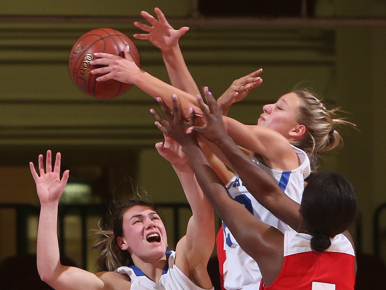 From left, Haldane's Abbey Stowell (25) and Alzy Cinquanta (20) battle for a rebound with Hamilton's Madison Hood (5) during the girls basketball Class C championship game at the Westchester County Center in White Plains March 4, 2017. Haldane won the game 47-39.