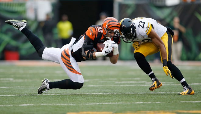 Bengals tight end Tyler Eifert stretches to catch a pass before being hit by Steelers free safety Mike Mitchell. Eifert left the game with a concussion.