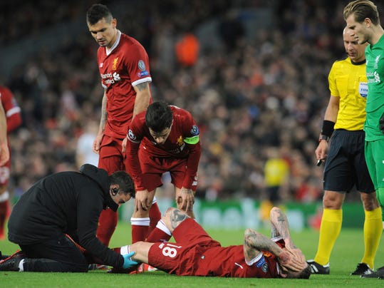 Liverpool's Alberto Moreno, center, receives a medical help during the Champions League Group E soccer match between Liverpool and Spartak Moscow at Anfield, Liverpool, England, Wednesday, Dec. 6, 2017. (AP Photo/Rui Vieira)