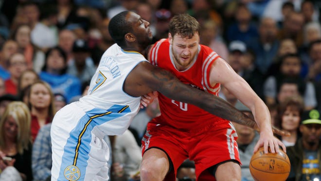 Denver Nuggets forward J.J. Hickson, left, reaches in to steal the ball from Houston Rockets forward Donatas Motiejunas on March 7, 2015, in Denver.