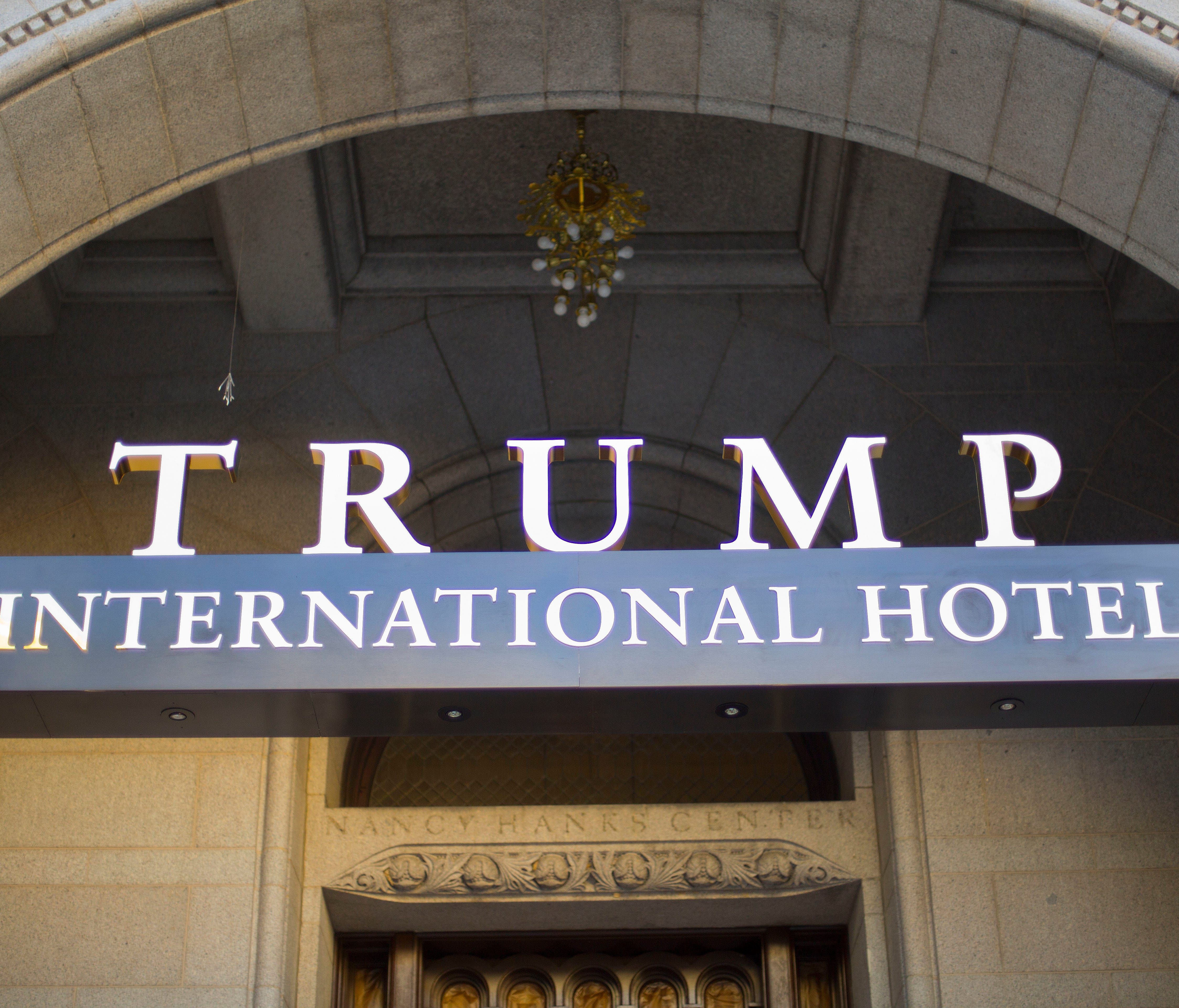 FILE - This Monday, Sept. 12, 2016, file photo, shows the exterior of the Trump International Hotel in downtown Washington. The Trump Organization says it will not ask guests at its hotels and resorts if they are using money from foreign governments 