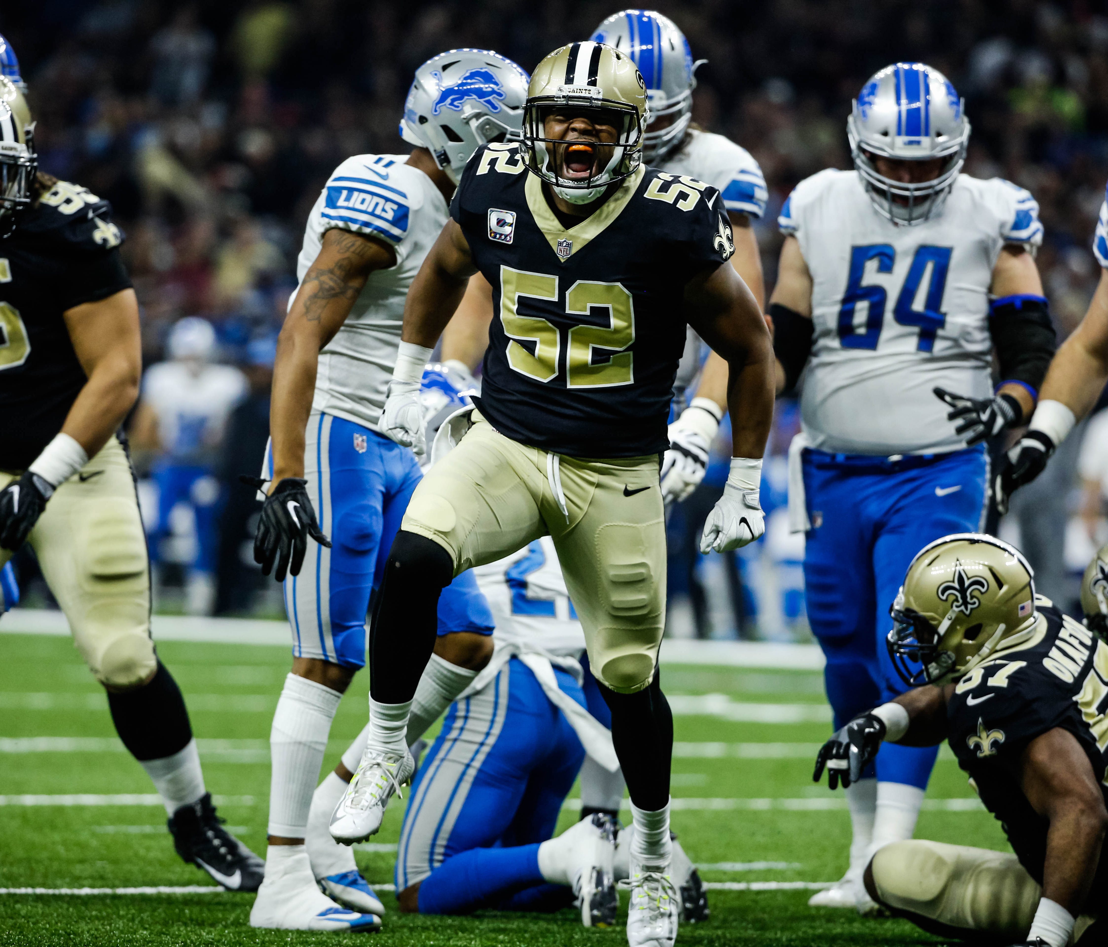 New Orleans Saints outside linebacker Craig Robertson (52) celebrates a defensive stop against the Detroit Lions during the first quarter of a game at the Mercedes-Benz Superdome.