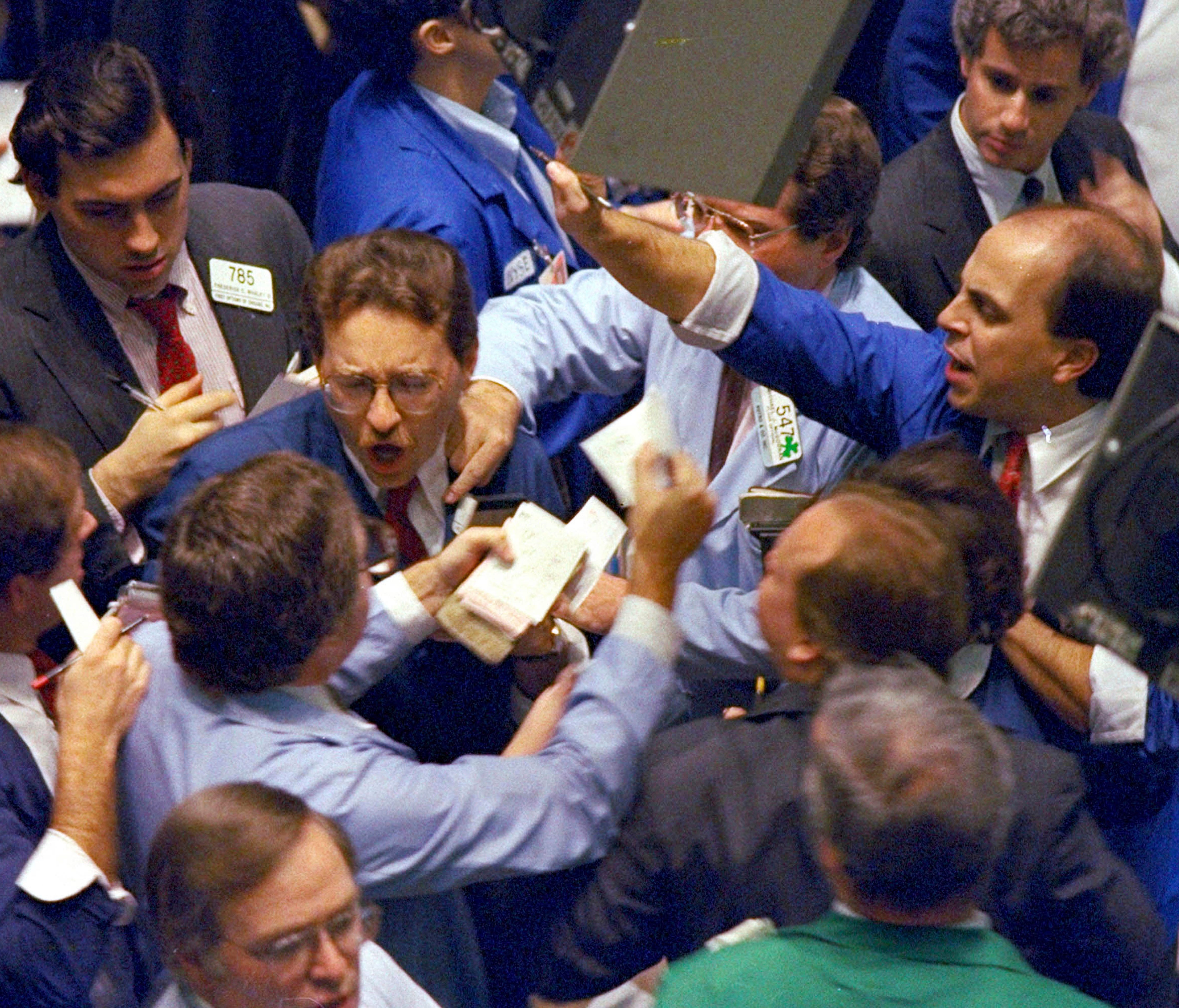 FILE - In this Oct. 19, 1987, file photo, traders work on the floor of the New York Stock Exchange, the day the Dow Jones industrial average fell more than 22%, its biggest one-day plunge ever.
