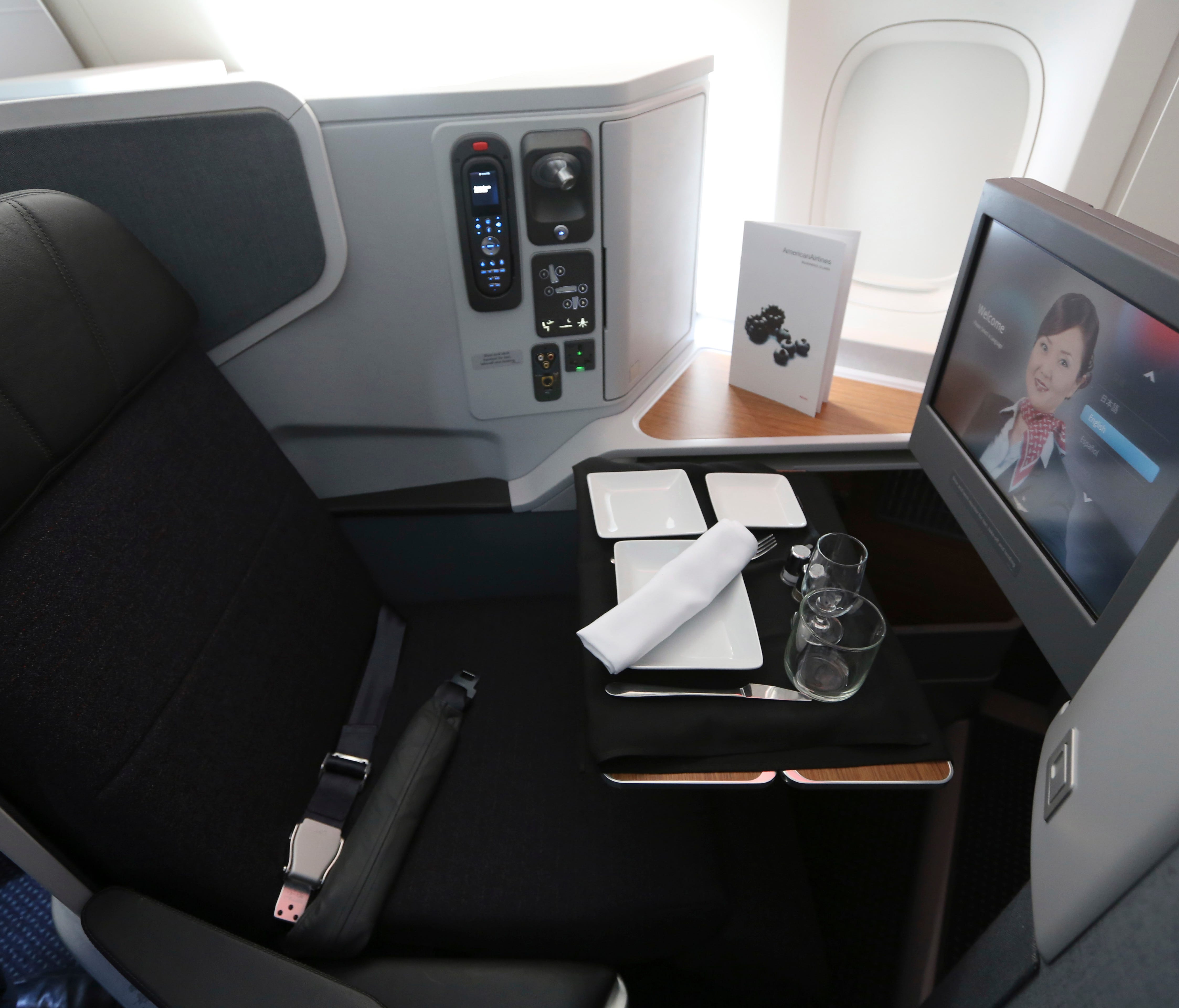 A first-class seat set up for a passenger's meal in an American Airlines Boeing 777-300ER.