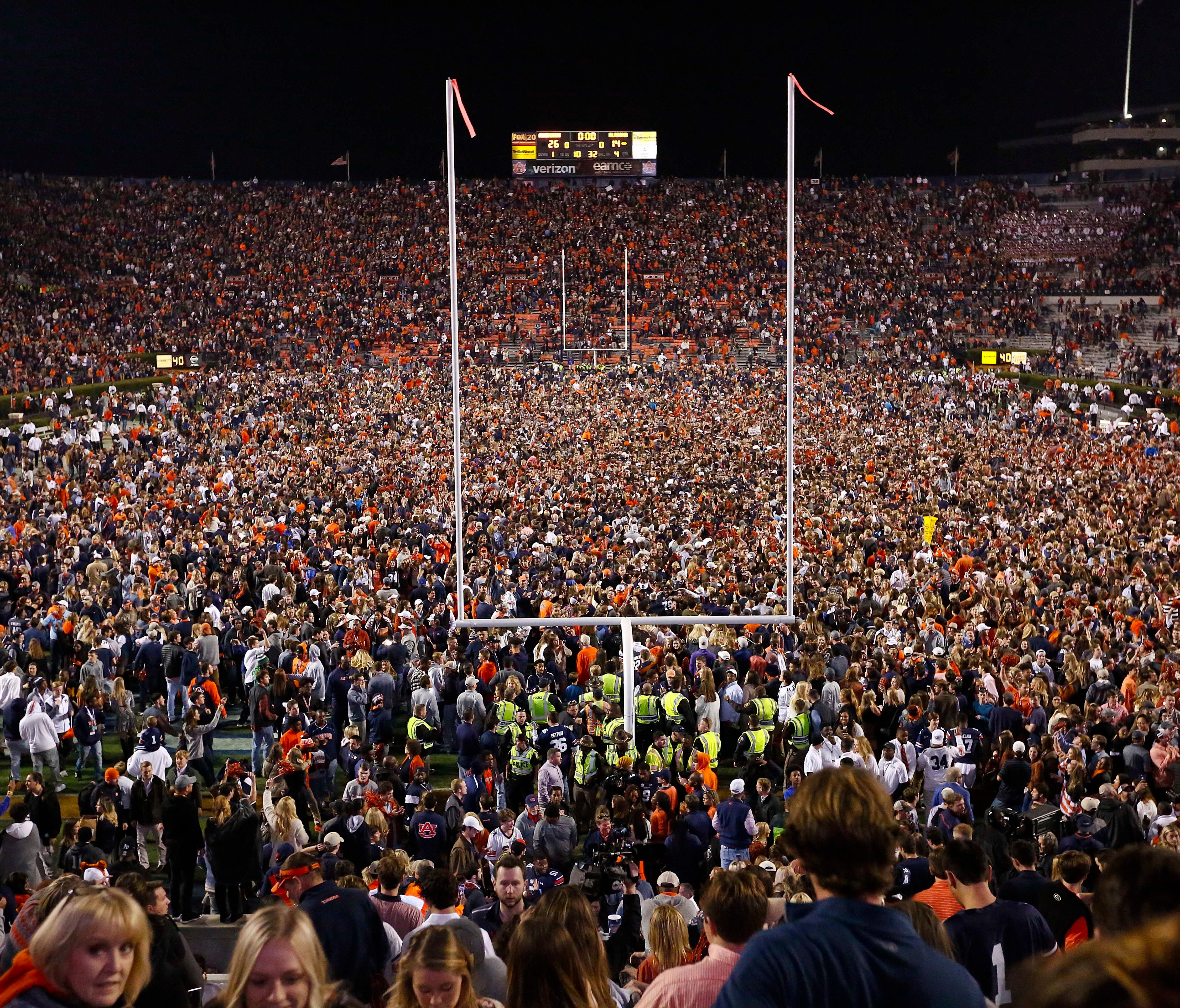 Fans rush the field after Auburn defeated Alabama in the Iron Bowl.
