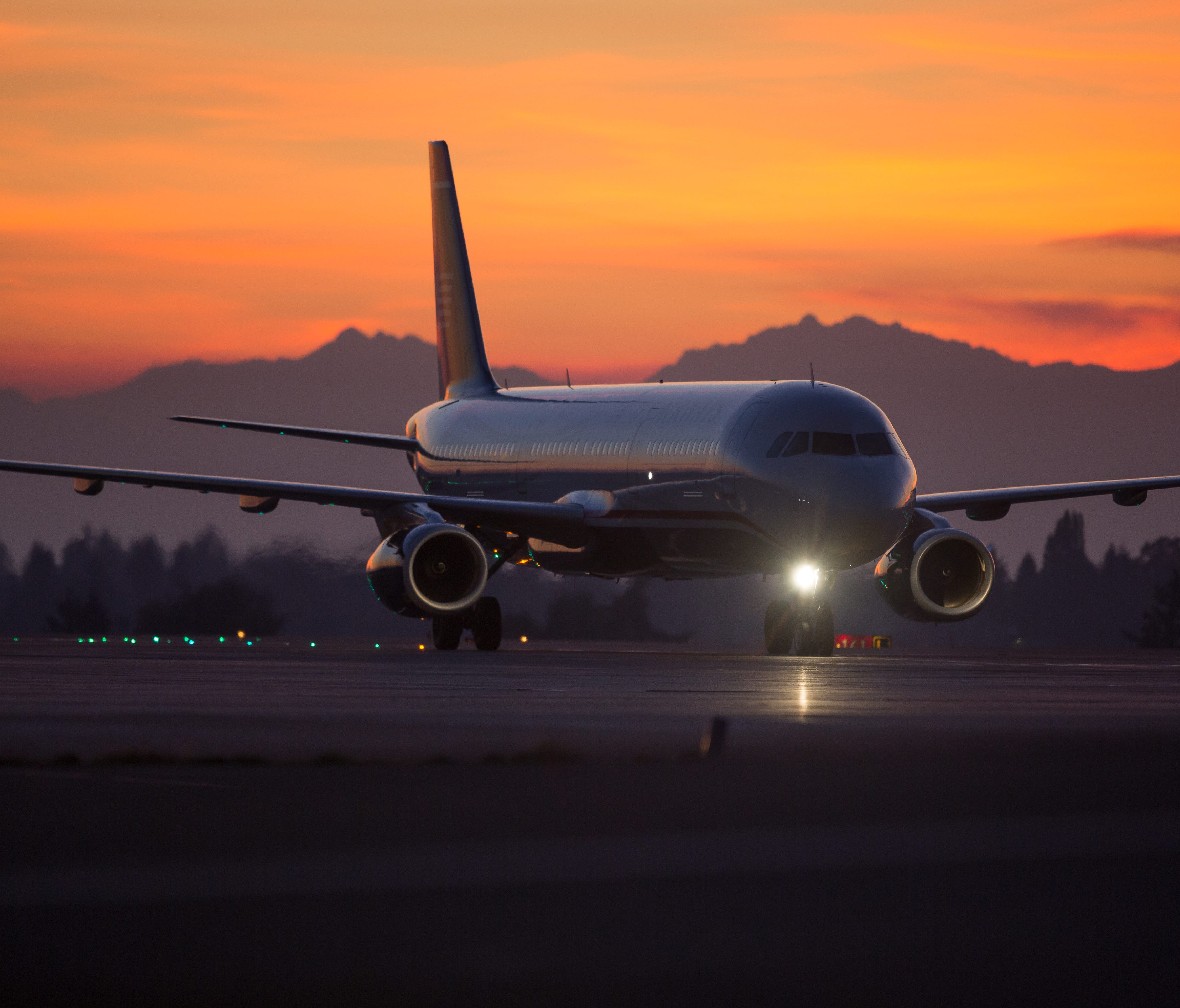 An airplane is seen at a sunset at Seattle-Tacoma International Airport in 2016.