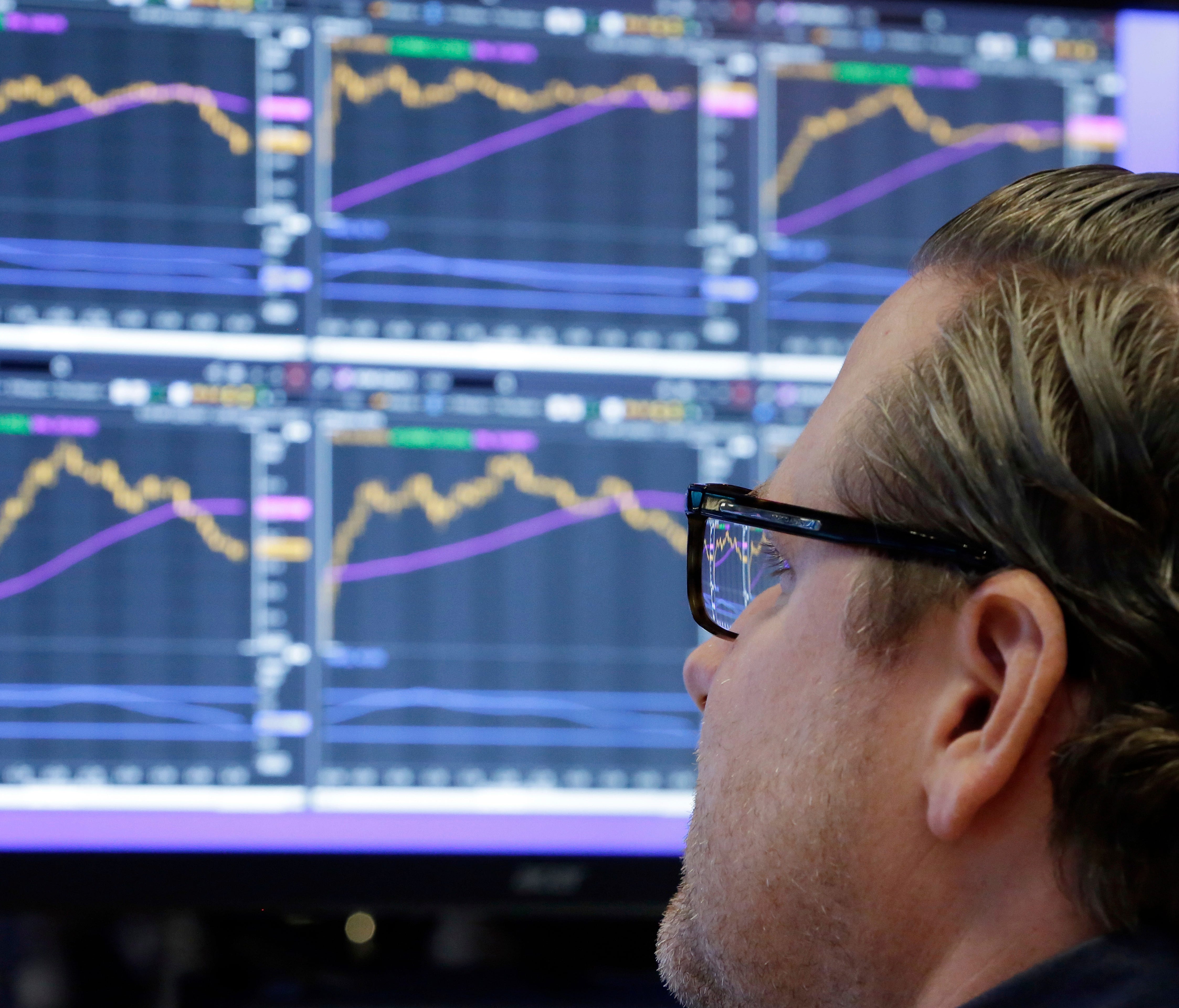 FILE - In this Monday, Dec. 4, 2017, file photo, specialist Gregg Maloney works at his post on the floor of the New York Stock Exchange. The stock market had a banner year overall, but there were plenty of big winners, and big losers, among individua