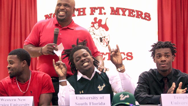 North Fort Myers head football coach Earnest Graham, top, celebrates  football player Mi'Cario Stanley's commitment to the University of South Florida Wednesday during National Signing Day.