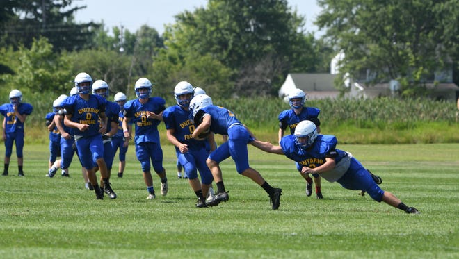 The Ontario Warriors football team practice special team Friday at the school's practice field.
