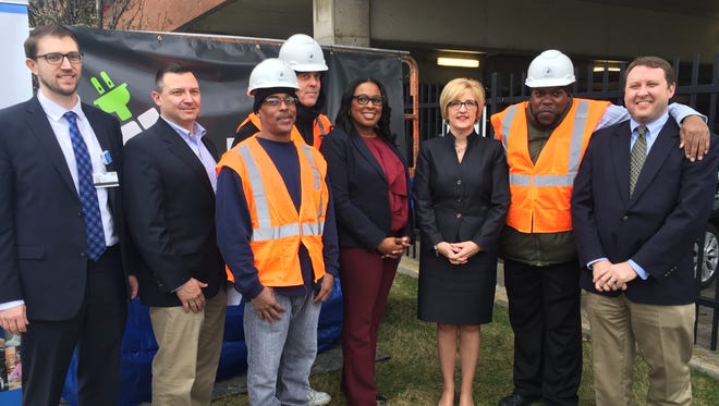 Mayor Lovely Warren poses with officials from Rochester General Hospital and workers from co-op startup ENEROC, on April 12, 2017.