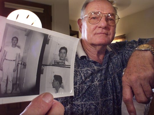 Carroll Cooley holds a booking mug of Ernesto Miranda from 1963. Carroll Cooley is a retired Phoenix police officer who did the 1963 interview of rape suspect Ernesto Miranda. The interrogation eventually led to the 1966 Miranda decision by the U.S. Supreme Court.