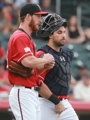 El Paso catcher Austin Hedges and pitcher Michael Kelly talk on the mound during a break Thursday. 