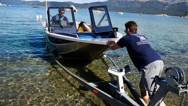 Andrew Cobourn, left, and Brian Limacher launch a Nevada State Park boat into Lake Tahoe at the Sand Harbor boat launch in Incline Village  on June 15 . The launch is expected to close around July 1  due to low water levels.