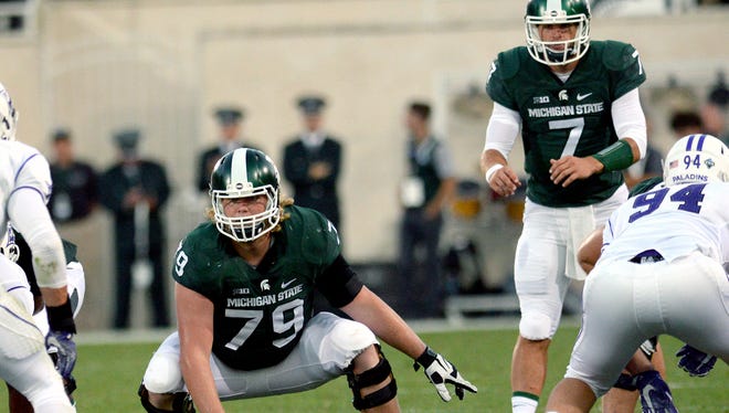 Michigan State University  senior offensive lineman Kodi Kieler (79) is set to snap the ball in the first half of play against Furman in the Spartan's opening game of the 2016 season Friday, Sept. 2, 2016, in East Lansing.