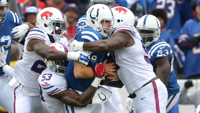 Indianapolis Colts quarterback Andrew Luck (12) is sacked by a swarming Buffalo defense in the second quarter of their game Sunday, September 13, 2015 at Ralph Wilson Stadium in Orchard Park NY. 
