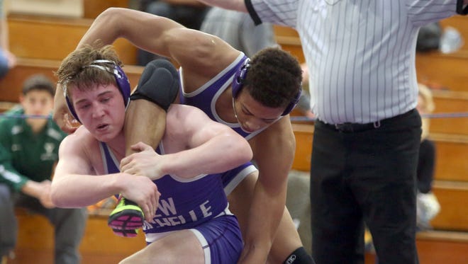 Jordan Wallace of New Rochelle, right, defeated Jake Logan, also of New Rochelle in a 170 pound match during the final round of the Section 1 wrestling postseason qualifying tournament at New Rochelle High School Feb. 4, 2017.