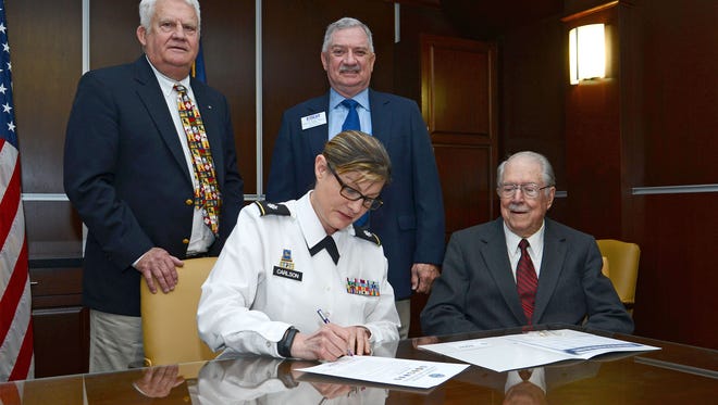Lt. Col. Katherine Carlson, a professor of military science at Northwestern State University, signed a Department of Defense State of Support of the Guard and Reserve to provide a visible reminder of the program’s support of the nation’s troops. Seated are Carlson with Major General (Ret.) Erbon Wise. Standing are John Pugh, state chair for the Louisiana Committee for Employer Support of the Guard and Reserve (ESGR), and ESGR Sector Chair Eddie Wise. According to Pugh, supportive employers are critical to maintaining the strength and readiness of the nation’s National Guard and Reserve Units.