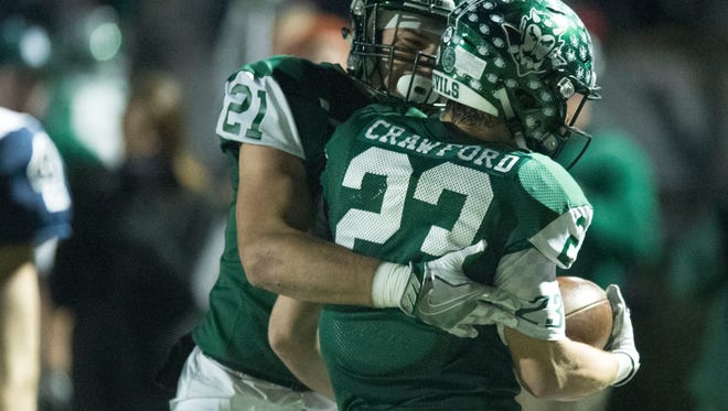 Greeneville's Cameron Hite, left, and Seth Crawford celebrate after Crawford intercepted the ball against Anderson County at Greeneville on Friday, November 17, 2017.