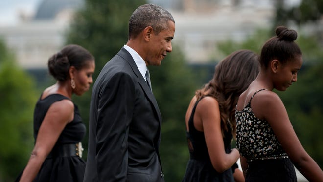 WASHINGTON, DC - AUGUST 30: First Lady Michele Obama, President Barack Obama, Malia Obama and Sasha Obama leave the White House to board Marine One on the South Lawn on August30, 2014 in Washington, D.C. The Obama's are travelling to New York State to attend the wedding of Sam Kass, Executive Director of "Let's Move!" and President Obama's Senior Policy Advisor for Nutrition Policy (Photo by Pete Marovich - Pool/ Getty Images) ORG XMIT: 459829523 ORIG FILE ID: 454394794