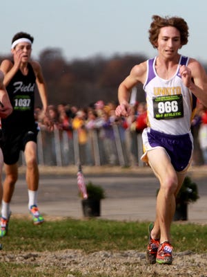 David Magda from Unioto sprints to the finish line at the state cross country meet.