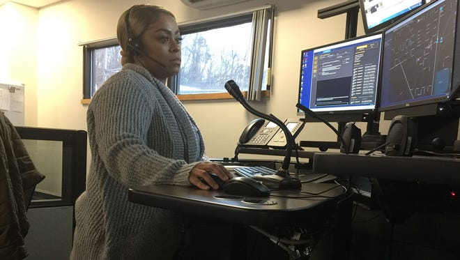 Camden County, N.J.,  dispatcher Tondaleya Bagby sits at her work station in Lindenwold, N.J. She and Camden County Police officers bought groceries for a Camden woman who called 911 because she had no food for her four children.