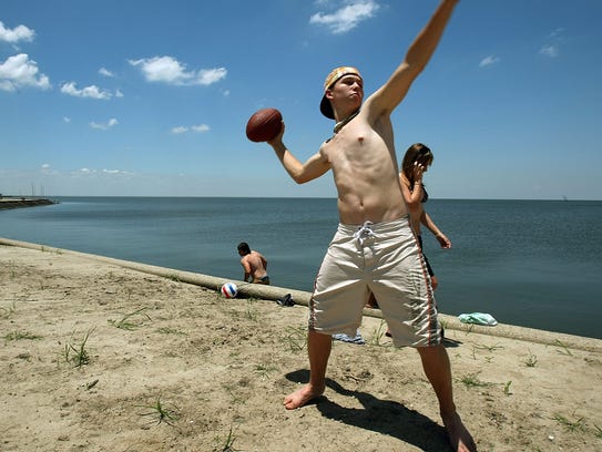 Neale Smith tosses a football on Lake Pontchartrain