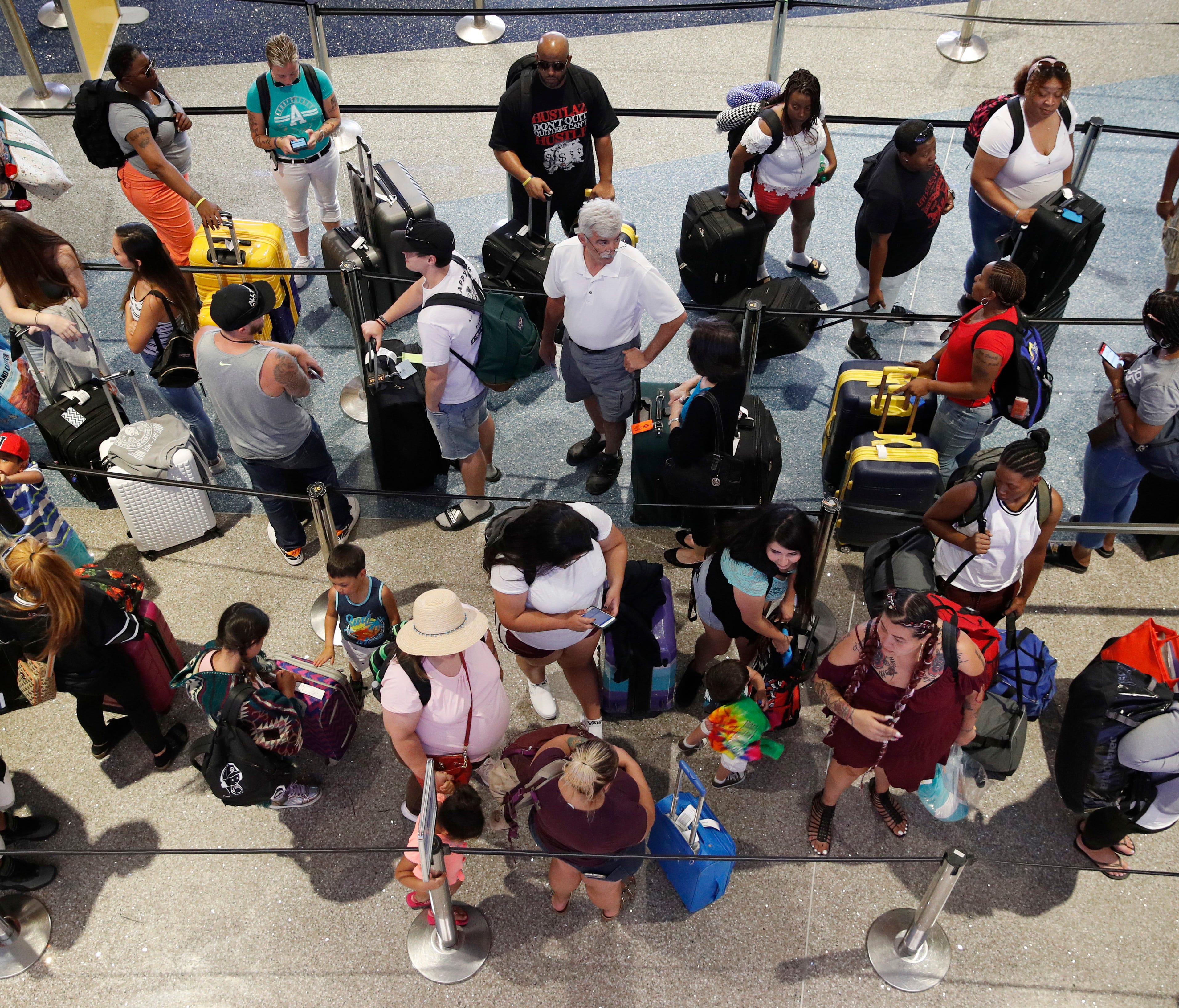People wait in line June 29, 2018, to check in at McCarran International Airport in Las Vegas.