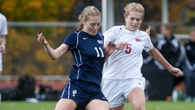 CVU’s Paige Dubrul (right) and Burlington's Callie Flynn try to get a foot on the ball during the Division I high school girls state championship in November.