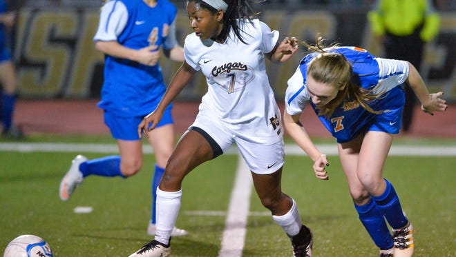 Northwest Rankin's Alyssia Davis (7) kicks a ball away from Madison Central's Caroline Parker (7) during MHSAA 6A North Girls Playoff action Tuesday in Flowood.