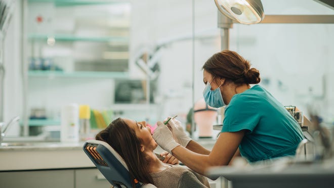 Dentist working on a patient's teeth.