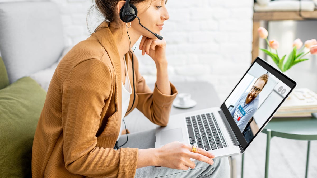 Woman wearing a headset while she works from home