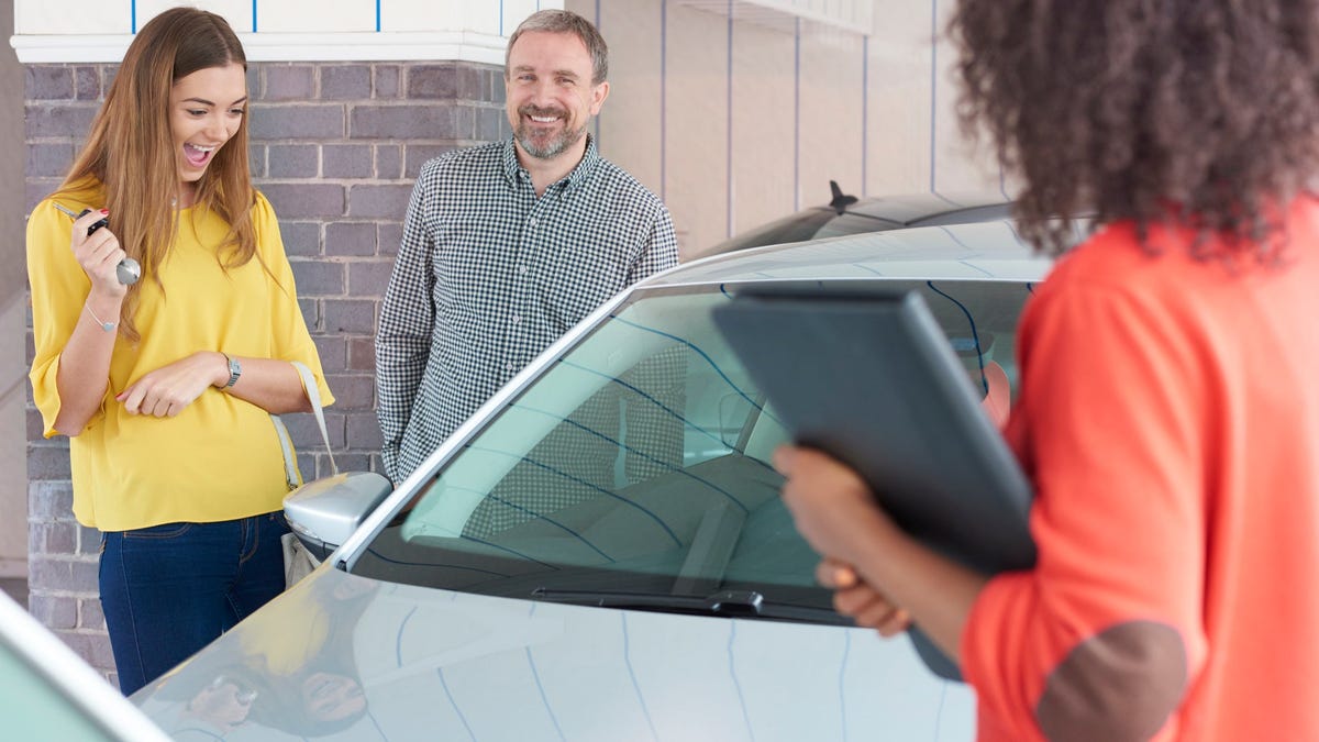 A father and daughter shopping for a used car together.