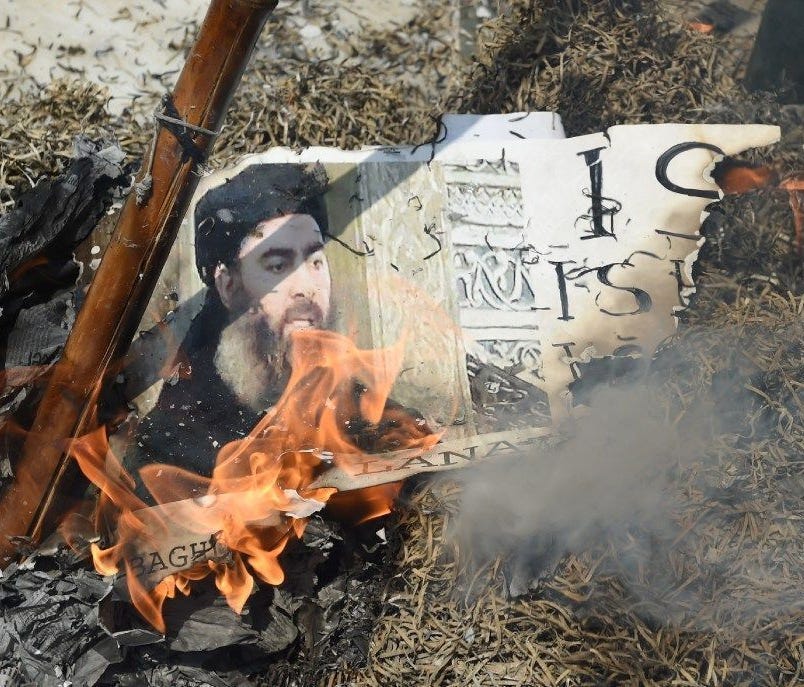 Indian Shiite Muslim demonstrators burn an effigy of the Islamic State group leader Abu Bakr al-Baghdadi during a protest in New Delhi on June 9.