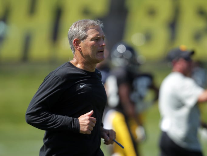 Iowa head coach Kirk Ferentz gathers players during