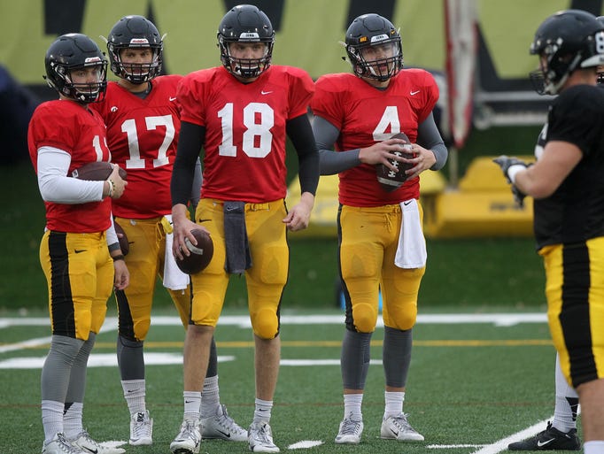 Iowa's quarterbacks line up for drills during practice