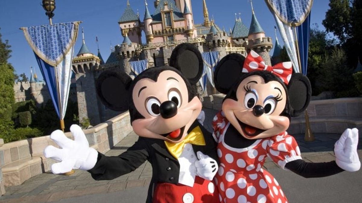 Mickey and Minnie Mouse greeting visitors to Disneyland.