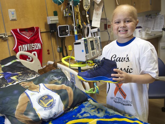 Brody Stephens, 7, poses by his Golden State-themed