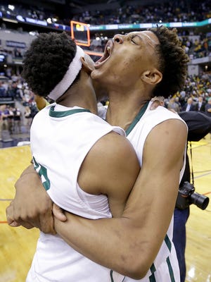 Crispus Attucks Tigers Nike Sibande (22),right, Zac Owens (12),left, after winning the IHSAA 3A Boys Basketball State Finals game Saturday, March 25, 2017, evening at Bankers Life Fieldhouse. The Crispus Attucks Tigers   defeated the Twin Lakes Indians   73-71.