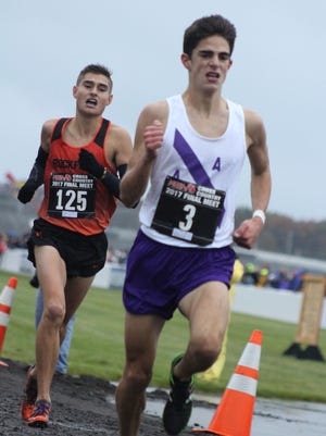Ten meters before the finish line, Ann Arbor Pioneer junior Nick Foster passes Rockford senior Cole Johnson to win the Division 1 state championship race.