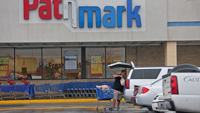 James Johnson, a loyal customer of Pathmark, unloads groceries after shopping at the Airport Plaza shopping center off North Du Pont Highway (U.S. 13), near New Castle. The Pathmark is in the process of liquidating merchandise before closing its doors.
