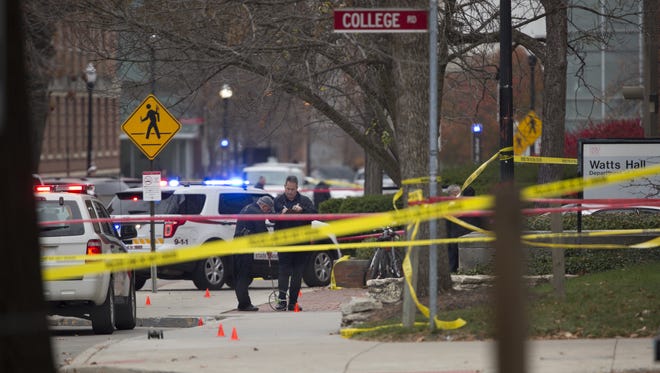 Investigators work the scene outside of Watts Hall on Ohio State's campus where police say a man attacked pedestrians with a vehicle and a butcher knife.