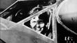 Amelia Earhart looking trough the cockpit window of