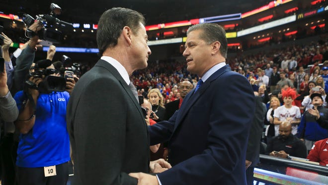 Kentucky's John Calipari and Louisville's Rick Pitino greet each other before the game at the KFC Yum! Center Dec. 22, 2016.