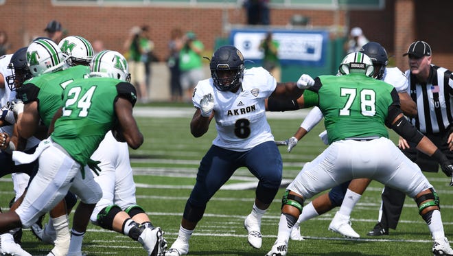Darius Copeland, a Fort Myers High graduate, runs toward the ball while playing defensive tackle for Akron in a recent game against Marshall.