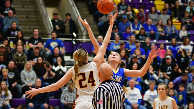 Madison's Nicole Brown and West Central's Kaitlyn Meadors go up for the opening tip in Friday's Class A semifinal game.