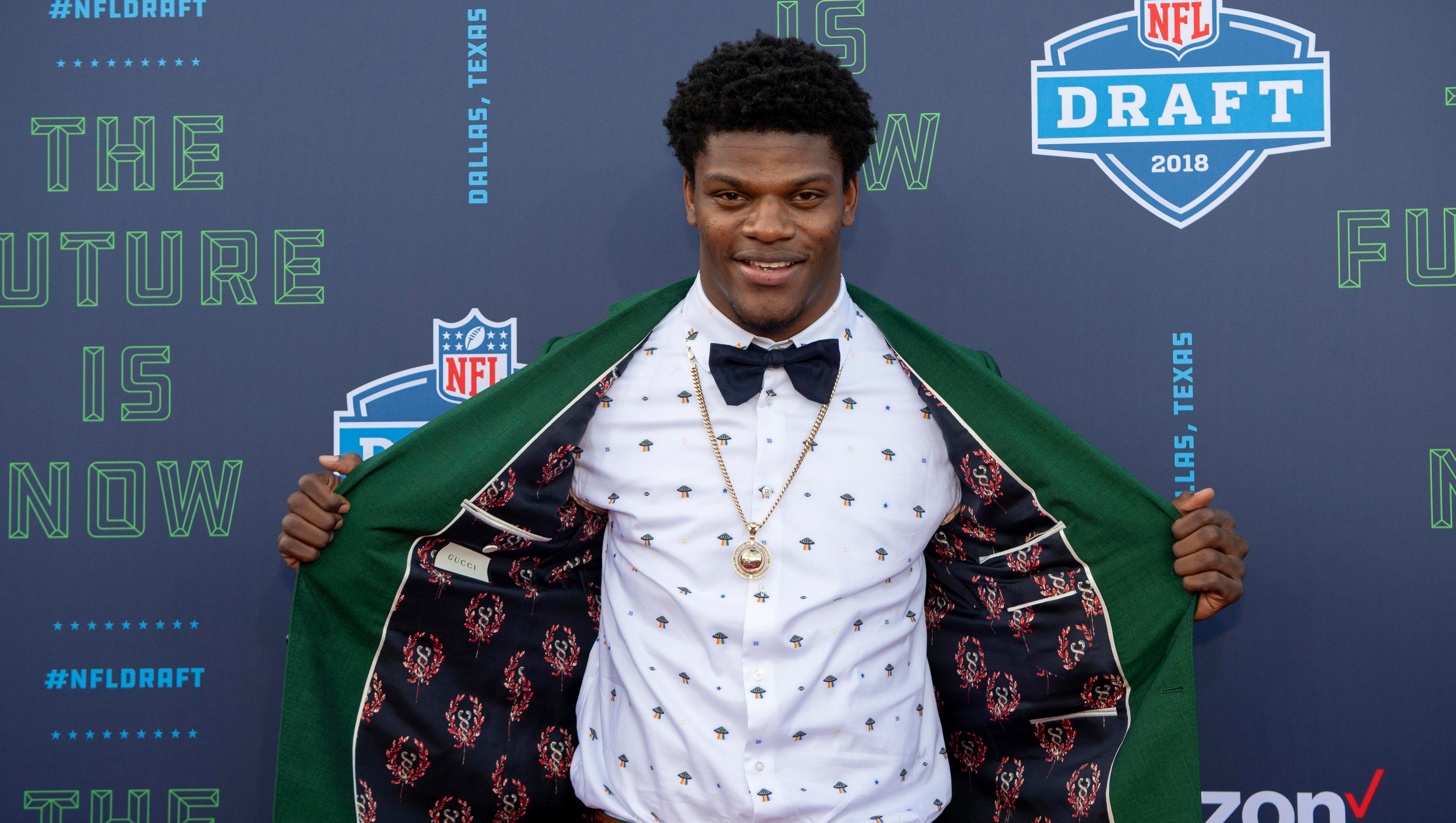 Lamar Jackson hits the NFL draft red carpet in all green suit
