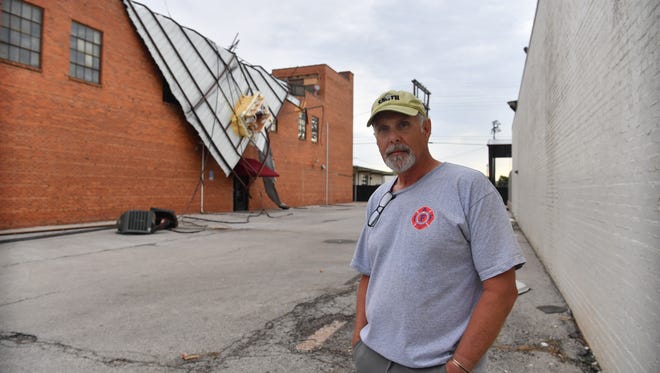 In this file photo downtown resident Bobby Whiteley stands near his property which sustained damage to the roof after a storm. Roof damage is the most reported property damage to homes in Texas.