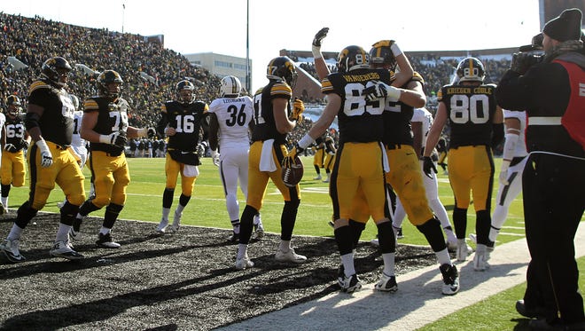 Iowa teammates celebrate after Matt VandeBerg's touchdown against Purdue on Nov. 21.