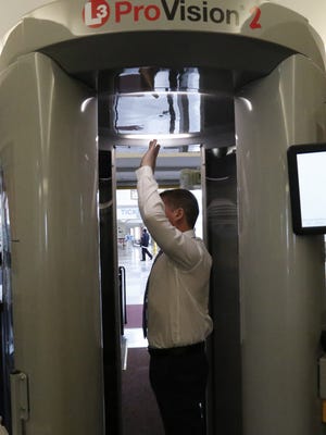 James Chapman, Deputy Assistant Federal Security Director for Screening at the TSA, demonstrates the new Advanced Imaging Technology screening machine at the Ithaca Tompkins Regional Airport on Monday.